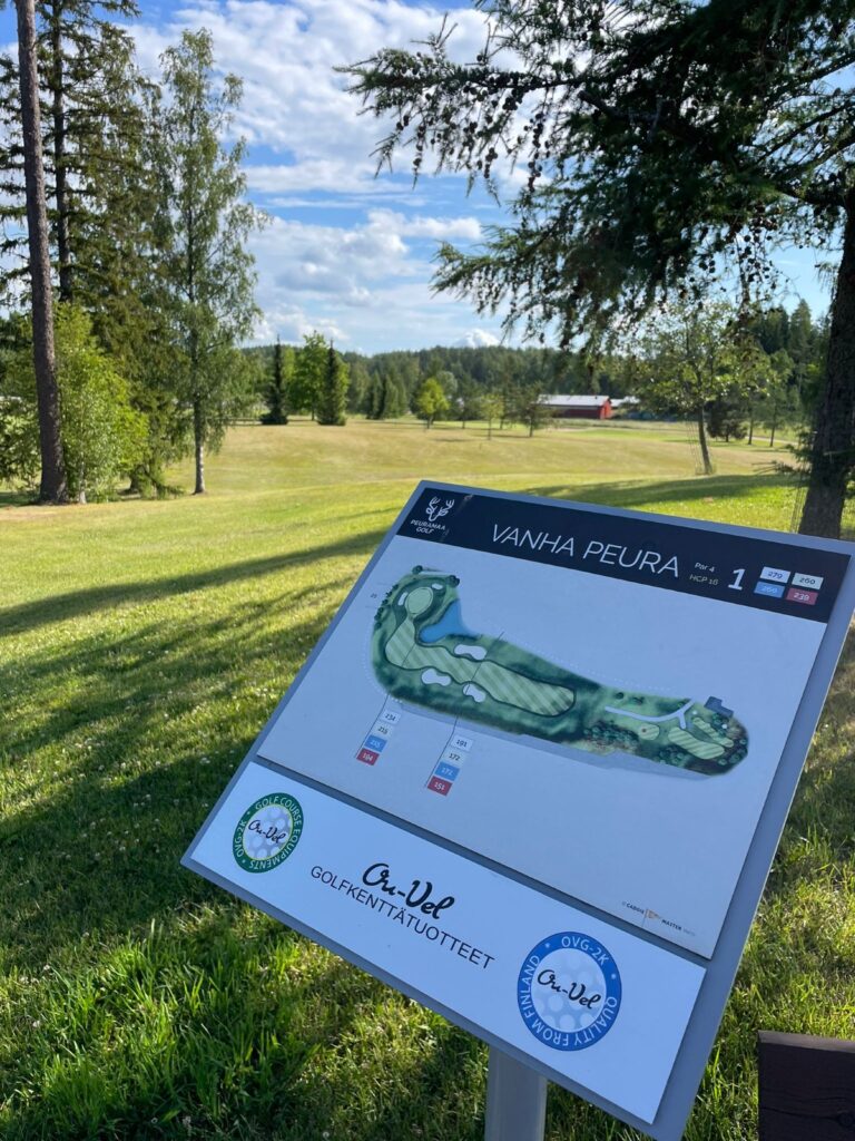 Vanha Peura -golfkentän väylän 1 opastaulu, jossa väyläkartta ja Ou-Vel Golfkenttätuotteet -logo